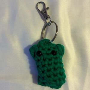 Homemade crochet mini pickle keychain.